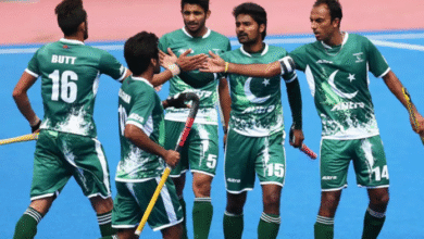 "Pakistan hockey team celebrating Olympic qualification with players raising sticks in victory"